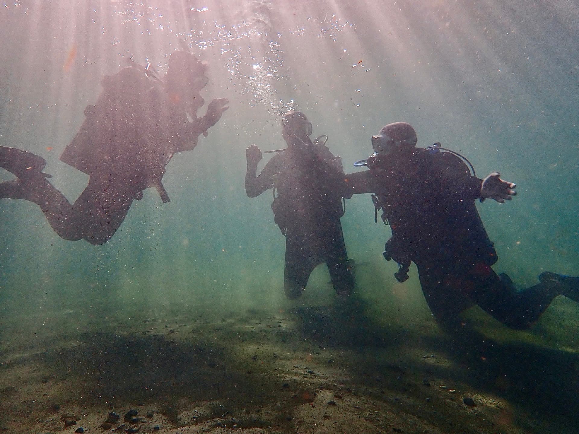 Scuba diver giving thumbs up after completing certification dive