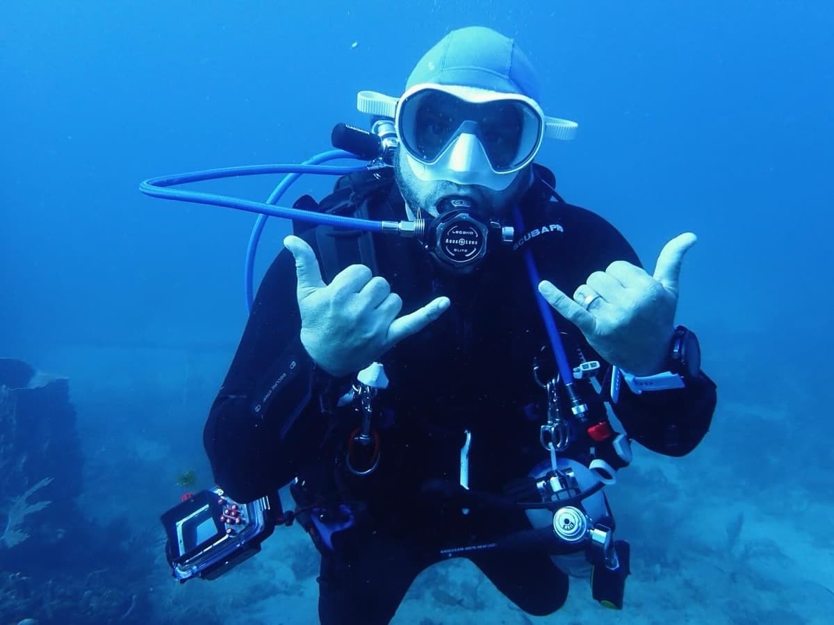 Chad Hanjora underwater giving shaka signs