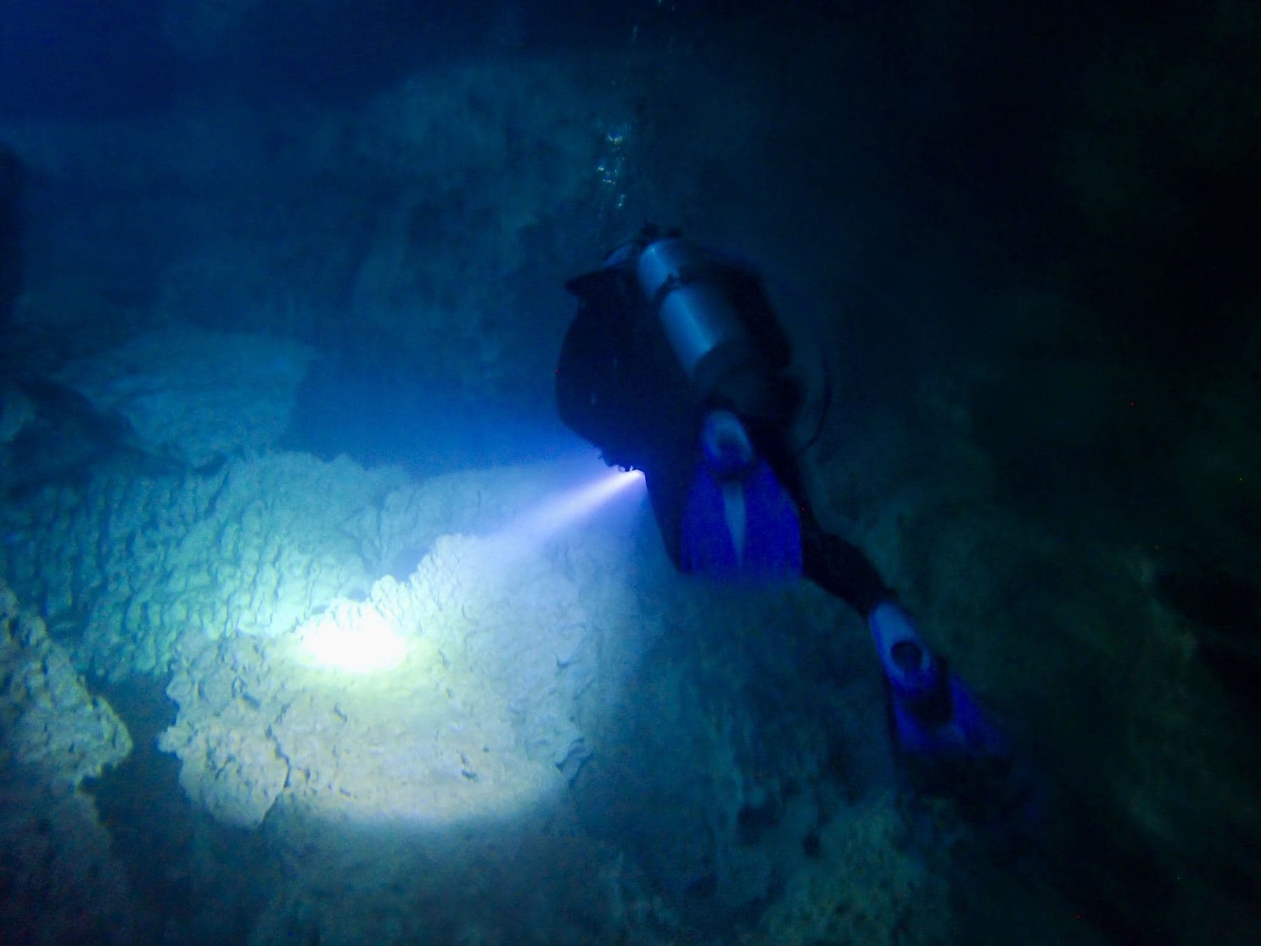 Working the edge of the cavern with a light