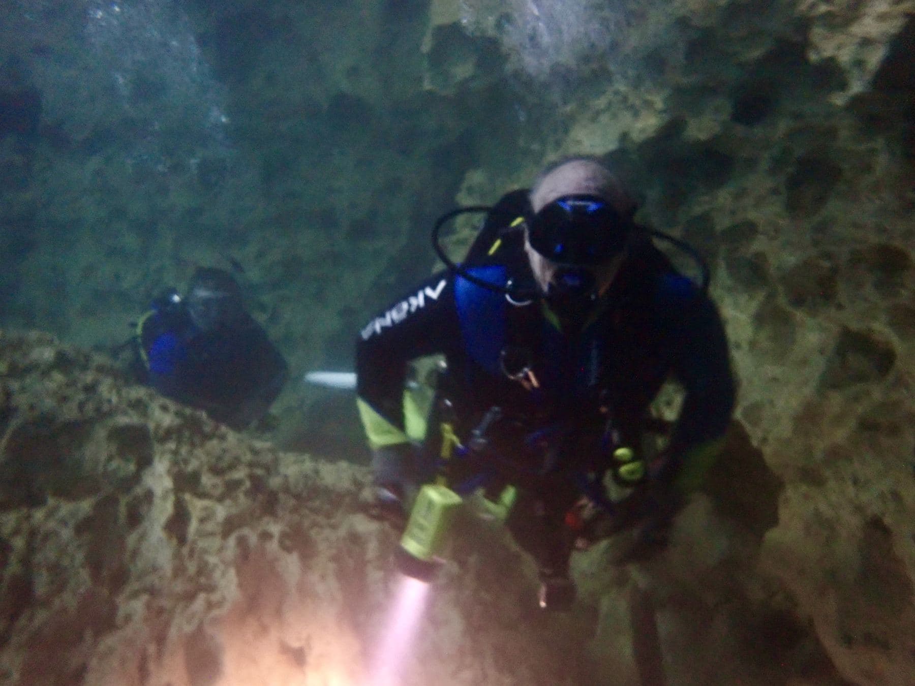 Two divers in the shadows
