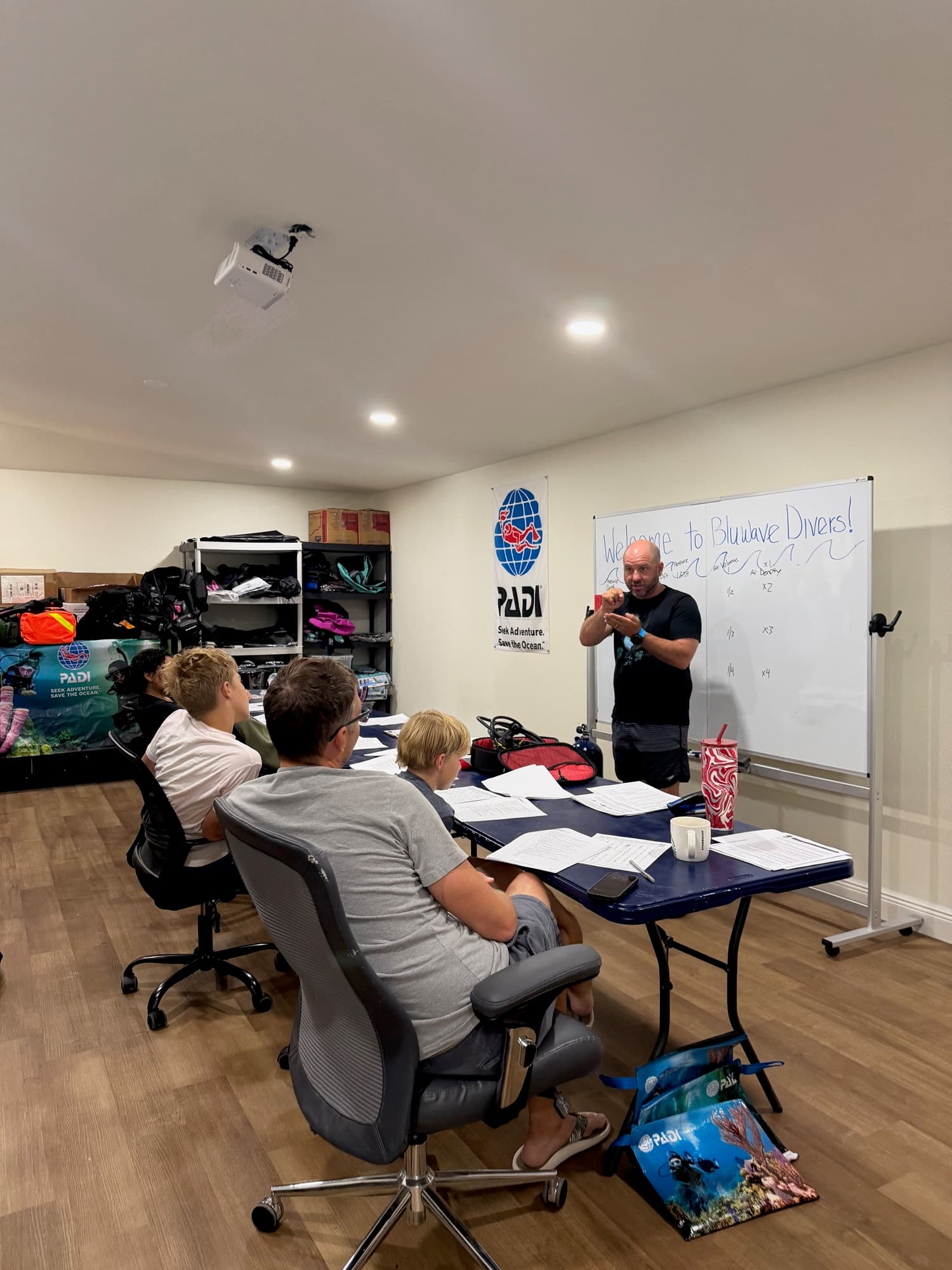 A PADI scuba class in session in the BluWave Divers classroom, College Park Orlando